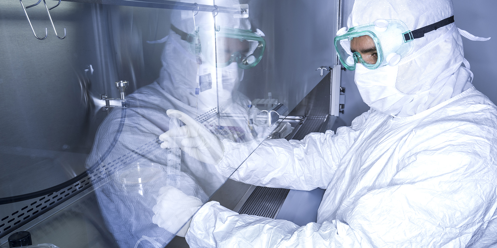 Scientist processing CAR-T cells in a fume hood